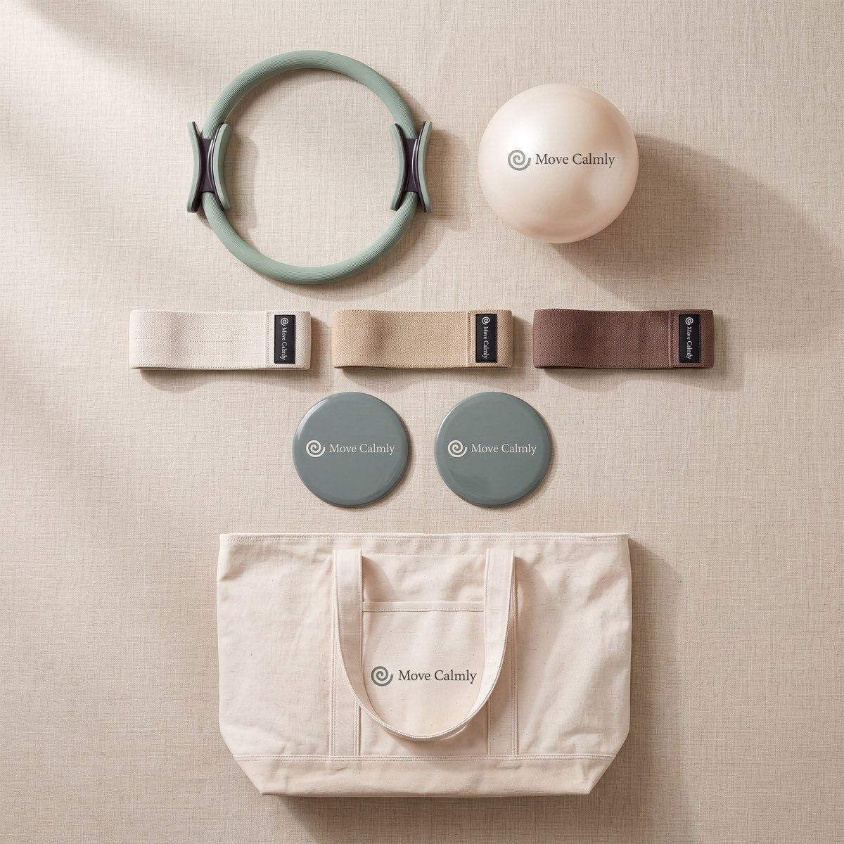 The complete Move Calmly Daily Flow Kit arranged on warm linen
